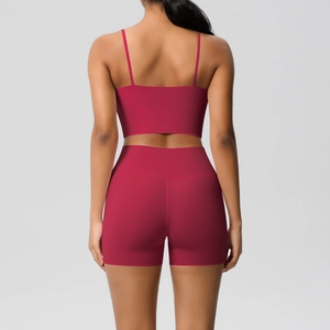 Back view of burgundy yoga set with cross straps sports bra and high-waisted shorts