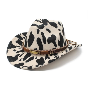 Cow print western cowboy hat with brown decorative band and gold feather charm