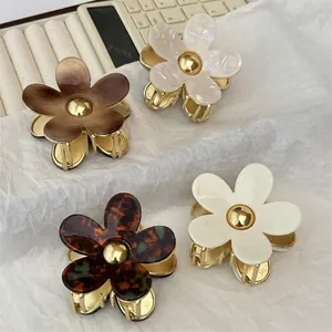 Floral acetate hair claws with gold-tone centers in four elegant marbled colorways