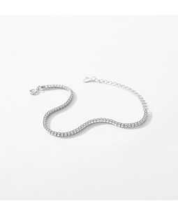 Detail of s925 silver tennis bracelet with sparkling zircons and heart charm