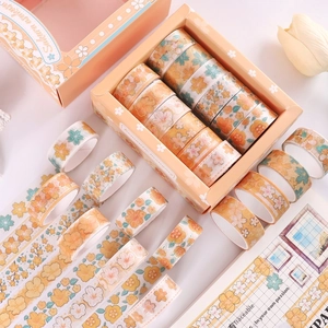 Detail of Sakura washi tape set with floral patterns and gold foil on stationery