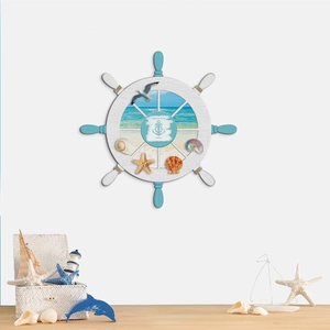 Mediterranean ship wheel wall decor with shells and starfish on grey background