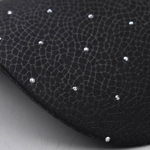 Detail of black faux leather texture with silver rhinestones and crocodile skin pattern