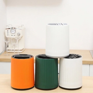 Rotating kitchen knife block and utensil organizer in multiple colors on a countertop