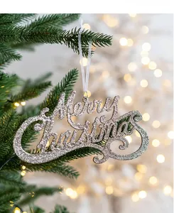 Macro detail of silver glitter Merry Christmas hanging sign on green pine tree needles