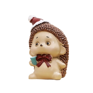 Cute resin hedgehog figurine wearing a red Santa hat and bow for Christmas decoration