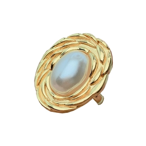 Vintage gold textured oval ring with a large center pearl on a clean white background