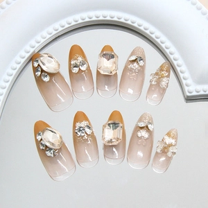 Amber gradient press-on nails with luxury rhinestones and crystal bow decorations