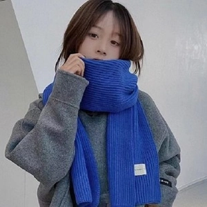 Close-up of blue wool scarf texture styled with a gray hoodie for cozy winter vibes