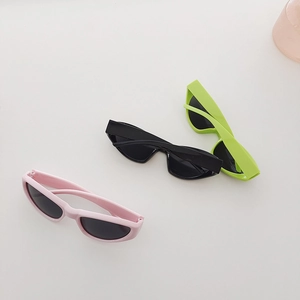 Detailed view of kids Y2K cat-eye sunglasses in pink, black, and vibrant green matte frames