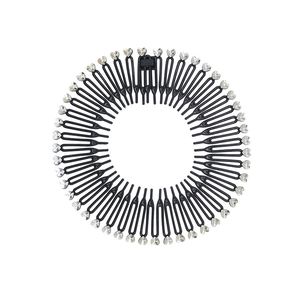 Detail of expandable hair comb with heart-shaped crystal rhinestones on black resin teeth