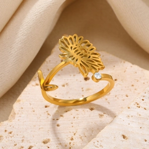 Macro view of adjustable sunflower zircon ring on beige stone base with warm lighting