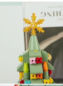 Macro detail of Christmas tree building blocks with golden snowflake and colorful ornaments