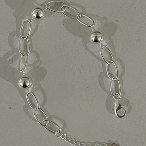Detail of 925 sterling silver beaded bracelet with lobster clasp and adjustable chain