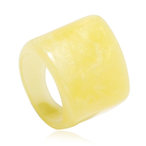Detailed view of a wide cream resin ring featuring a pearlescent marble texture finish