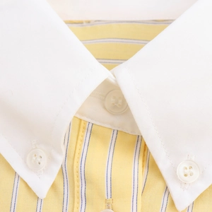 Close-up of contrast white point collar on yellow and blue striped shirt dress detail