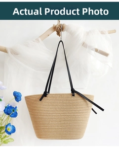 Detailed close-up of woven paper straw tote with minimalist black PU knotted handles