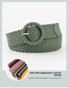 Detail of green woven belt with leather-wrapped buckle and multiple color swatches