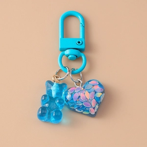 Blue resin bear and glitter heart charm detail on matching lacquered key ring