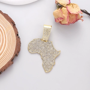 Hip hop gold plated Africa map pendant with sparkling crystals on a minimalist background