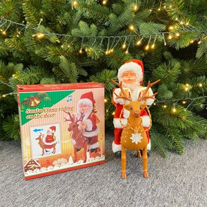 Electric musical Santa Claus riding a reindeer toy with festive holiday gift packaging