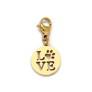 Macro detail of a golden stainless steel LOVE charm with a heart paw print and lobster clasp