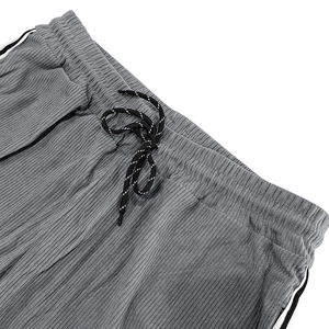 Detailed macro view of the drawstring waistband on gray corduroy casual sport pants