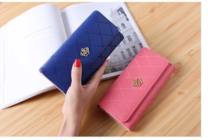 Detailed view of long PU leather wallets in blue and pink with quilted crown pattern