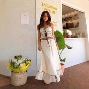 Two-piece ivory summer set with bow strap top and ruffled long skirt in bohemian style