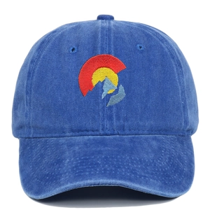 Macro view of blue washed cotton denim fabric with Colorado flag mountain embroidery