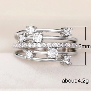Anillo multicapa plateado brillante con circonitas microengastadas y diseño cruzado