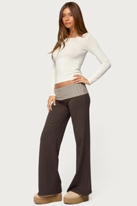 Detail of wide-leg brown trousers with unique striped fold-over waistband design