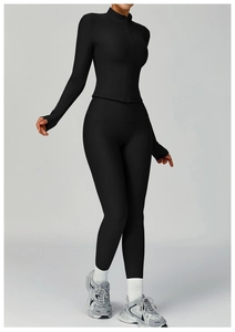 Detail of black ribbed yoga set featuring full zipper stand collar jacket and high waist pants