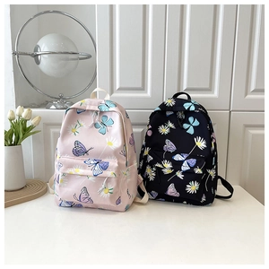 Detail showing pink and black school backpacks with butterfly and daisy floral prints