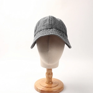Detailed view of the washed gray denim texture and stitching on a vintage sun hat