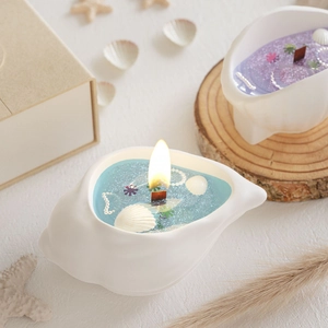 Detail of seashell candles with glitter and pearl accents on a wooden wick