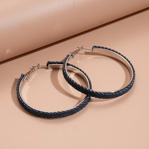 Fashionable denim fabric wrapped silver needle hoop earrings on pink background