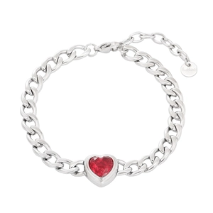Detailed macro shot of silver stainless steel Cuban chain bracelet with red heart zircon