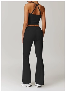 Rear view of black backless yoga vest with criss-cross straps and flared gym pants
