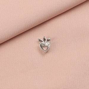Macro detail of a heart-shaped stainless steel pendant base for DIY jewelry making