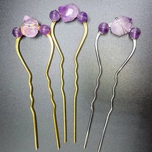 Detail of three U-shaped hairpins featuring natural purple amethyst and metal wire wrap