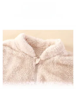 Close-up of windproof stand collar and soft plush fleece texture on kids winter jacket