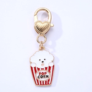 Golden alloy popcorn dog pendant with heart-shaped clasp on a blue background