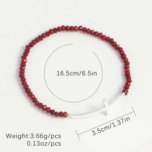 Detail view of red beaded bracelet with a silver cross showing exact size and weight