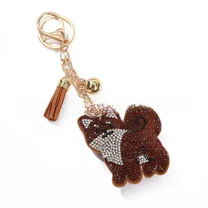 Macro detail of cartoon Shiba Inu keychain with sparkling rhinestones and suede tassel