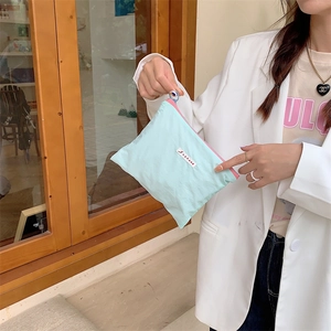 Detail of macaron nylon organizer bag with pink zipper contrast and white label