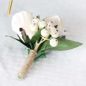 Detail of handmade groom boutonniere featuring white rose, berries and jute wrapped stem