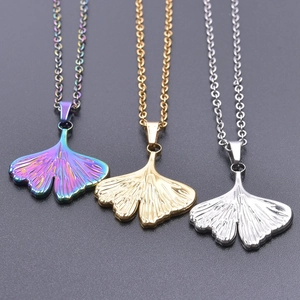 Macro view of ginkgo leaf pendants in rainbow, gold, and silver stainless steel finishes