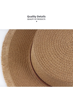 Close-up of woven straw hat featuring a slim leather band and decorative tassel edges