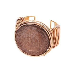 Handmade gold wire-wrapped wide cuff bracelet with a brown resin oval stone